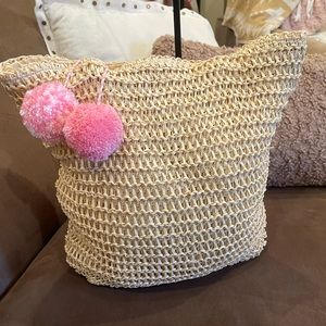 SOLD EUC straw tote bag with two adorable pink pompoms. Measures 15” x 16” x 4”